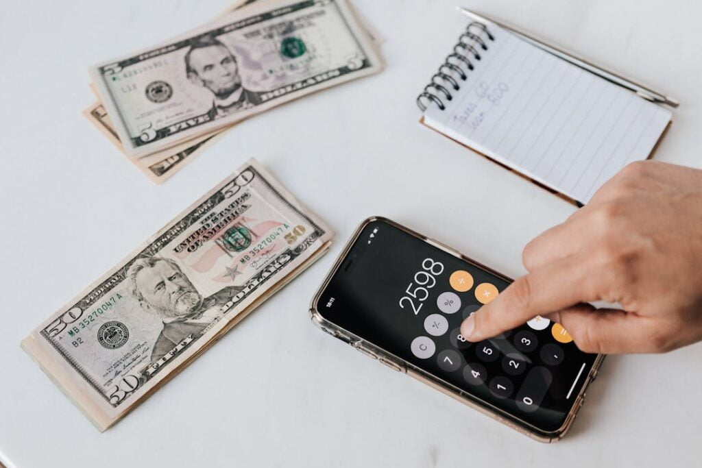 A photo of a person using a calculator and notebook, symbolizing the beginning of financial planning.